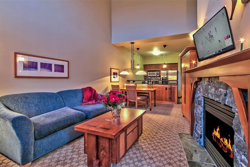 Living room with gas fireplace, sofabed and LED HDTV.