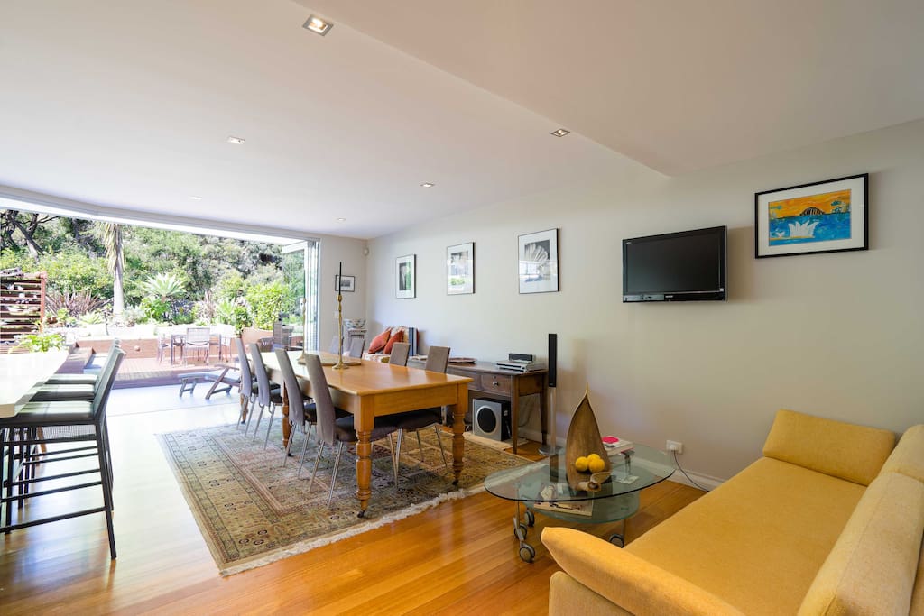 The large dining table seats 8. Enjoy true alfresco dining with the bifold glass doors opening for true indoor/outdoor living