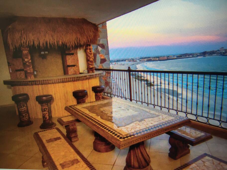 Tiki bar with wet bar and flat screen TV