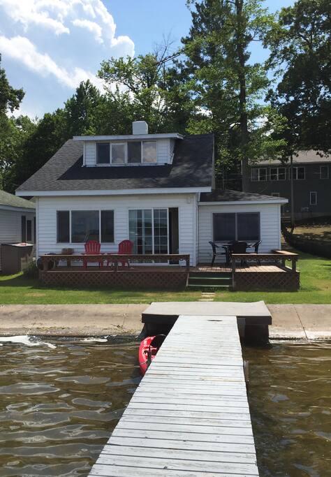 The rear of the cottage. We have a private dock if you want to bring your boat, plus a 2 person kayak for your use. Our shed is stocked with lake floaties and tubes for your use. The large deck has a patio table for six, but also has bench seating to sit over a dozen people. There is also a Weber grill and firepit for those long summer cook-outs.