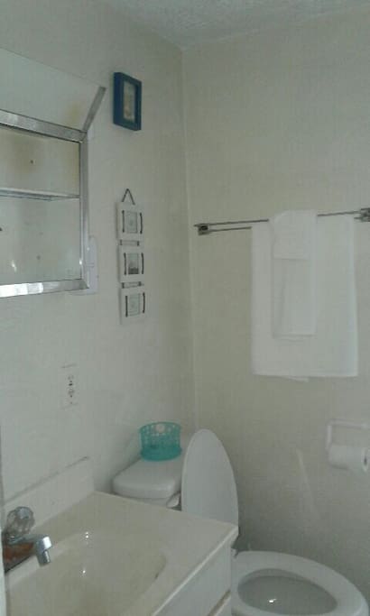 Shared bathroom with full size tub and shower.