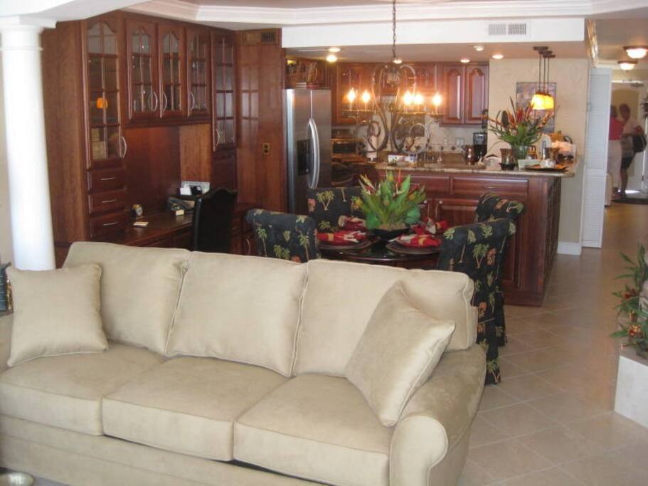 Spacious Living Room and Dining area with tile floors, cherry cabinets and desk area.