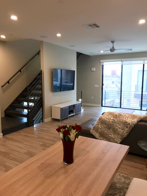 Sit at the kitchen table while watching TV on our 65 in. smart TV - full cable included! Need to unwind? Walk up the stairs to the bedrooms!