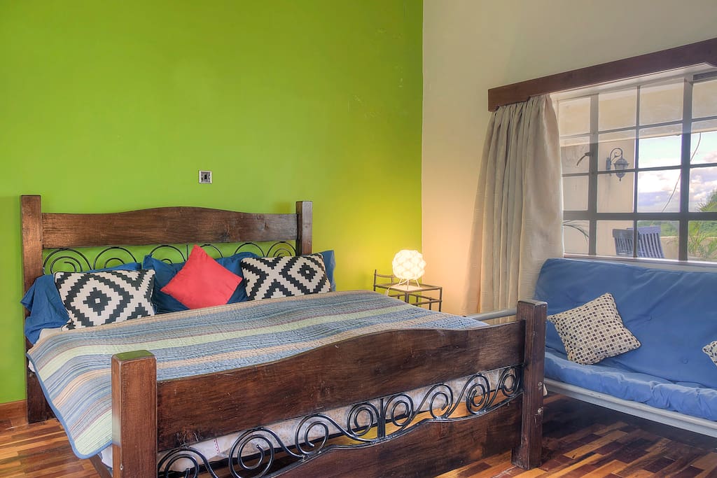 The settee in this bedroom doubles up as a sofa bed, comes in handy for families with children