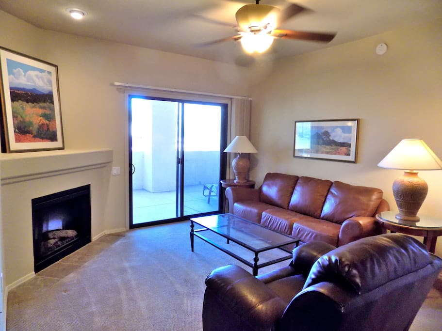 Welcome to our place, your home away from home. Comfortable living room with leather sofa and rocker recliner.