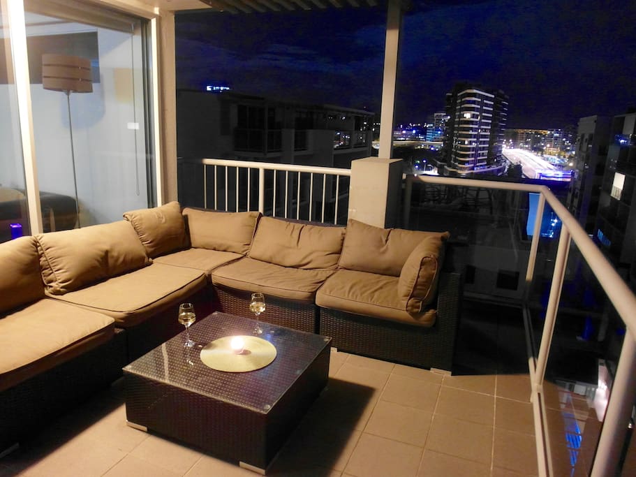 Enjoy the view from this large outdoor coach on the rooftop
