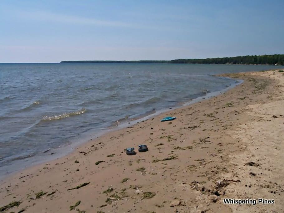 The sand beach changes with every storm. You can see Cave Point in the distance.