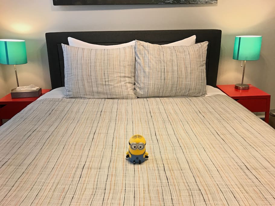 Bedroom with Queen bed and our luxury mattress, high thread count sheets, and luxury pillows. Hey is that a Minion there too? ;)