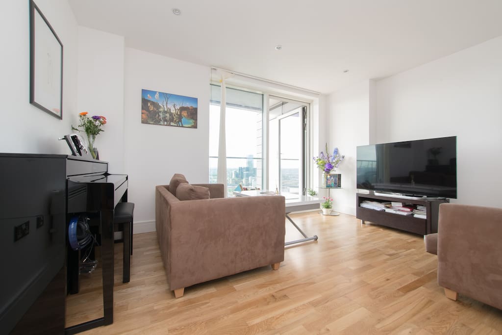 Communal areas - 4k TV, piano and door leading onto balcony