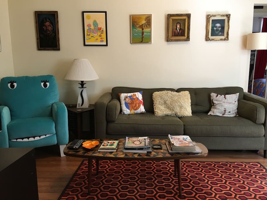 Living room includes a long sofa that makes a surprisingly comfy bed for one.