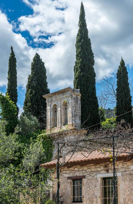 The house stands next to an old bell tower of great historical value