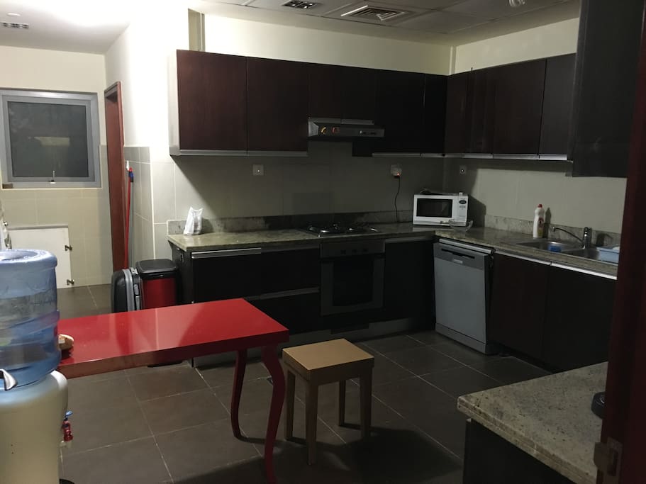 Large kitchen with a lot of utensils and dish washer
