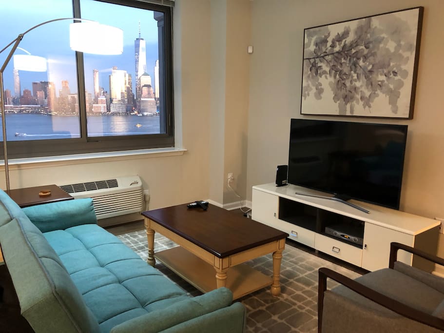 Whether by day,Perks of staying in Jersey City: million dollar Manhattan skyline views with more space and a quick ride into the city.