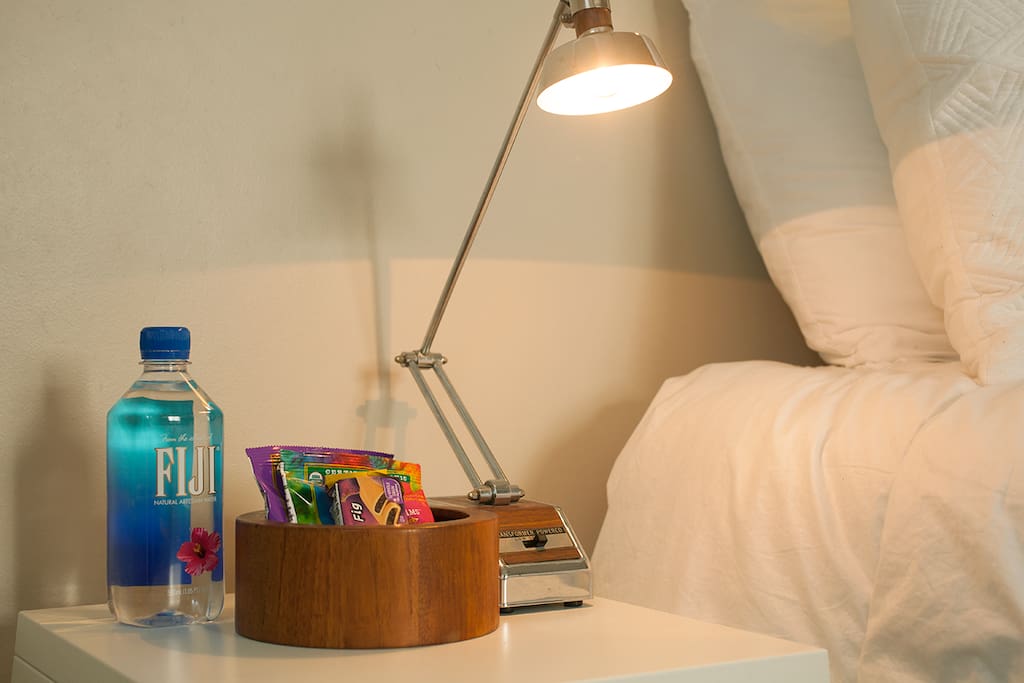 This is the nightstand in your bedroom. It has a 1960's Tensor lamp with Hi, Low, and Off settings. The turned walnut bowl is 1960's Dansk.
