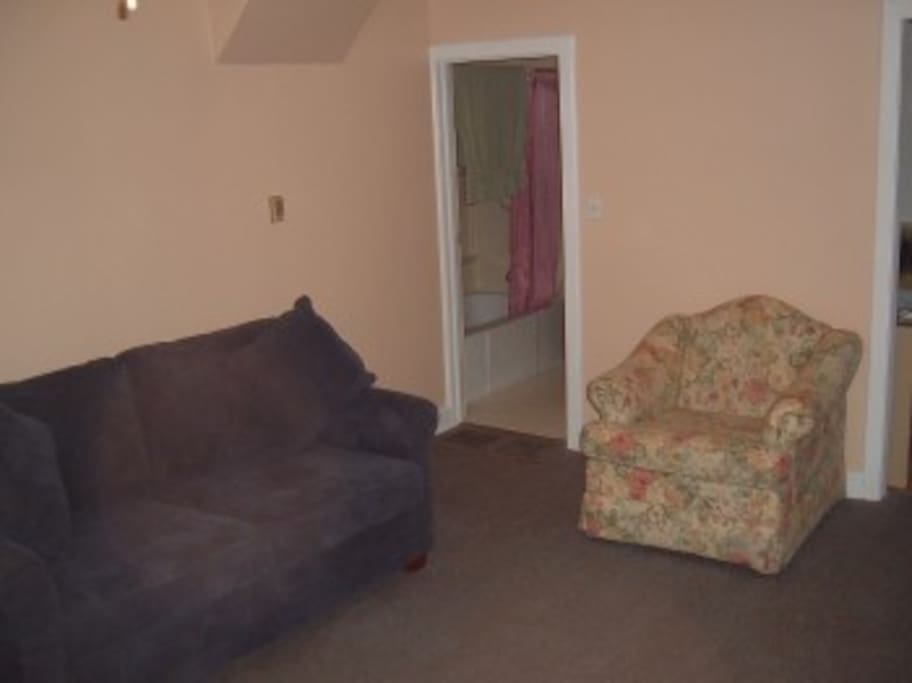 Living Room, looking into main floor bathroom (4 pc, tub, shower, sink, toilet)