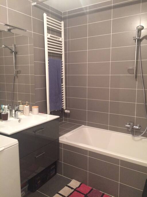 Salle de bain avec baignoire et machine à laver