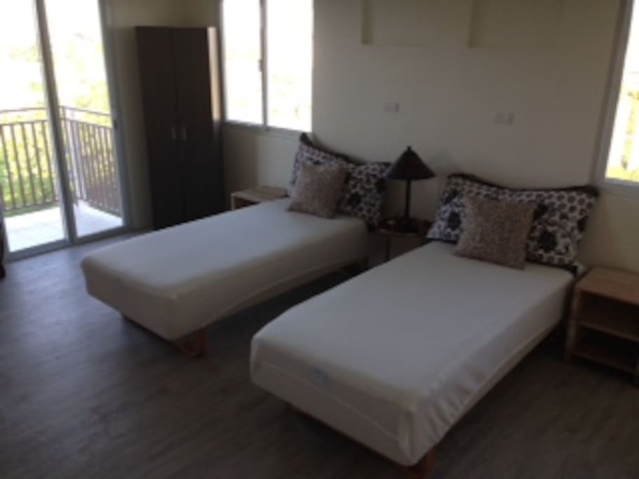 Two single beds with comfortable mattresses, adhering to body contour.