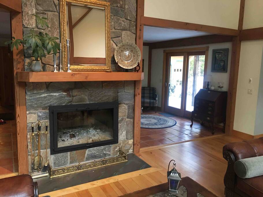 Double-sided New England granite log fireplace graces the post-and-beam 'Great Room' with its 28-foot ceilings.