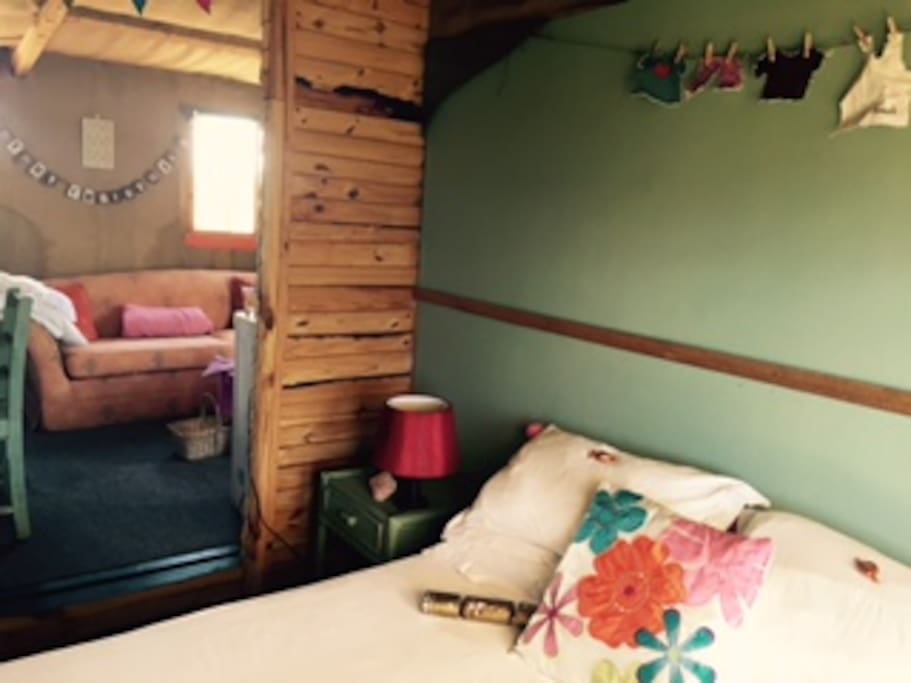 Bedroom and lounge inside the Pink cottage