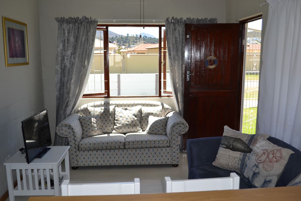 The lounge has a TV and a small sleeper couch
