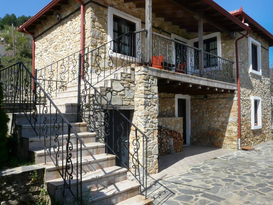 Side view of the house. Two main entrances to the two floors and view of the balcony.