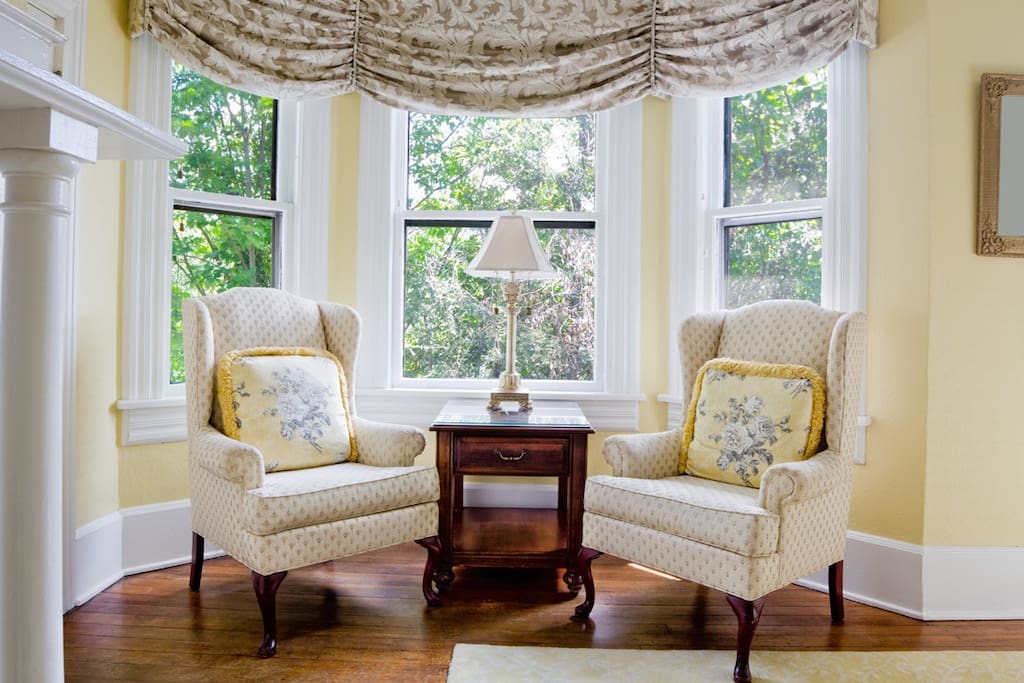 Blue Ridge Room
The Blue Ridge Mountains were named for the blue-gray haze that veils her rolling hills. Cool, crisp mountain air and timeless natural beauty continue to draw people to the city of Asheville. The Blue Ridge room is the ultimate in comfort and light with a gas fireplace and a bay window that offers an idyllic nook for reading in cozy wingback chairs in the morning sun.
The room features a cherry wood four poster king size bed as its focal point and its private bathroom is complete with a new tile shower. The room is also equipped with a closet, gas fireplace, plush robes for your use during your stay, a television with cable, HBO, Showtime, and complimentary Wi-Fi.