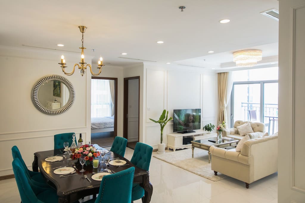 Dining area: solid wooden table, soft velvety upholstered chairs and european styled hanging lamp to set the mood.