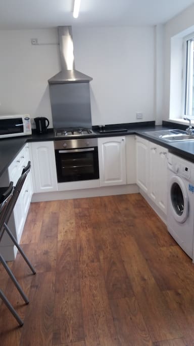 Fully fitted kitchen with washer and microwave