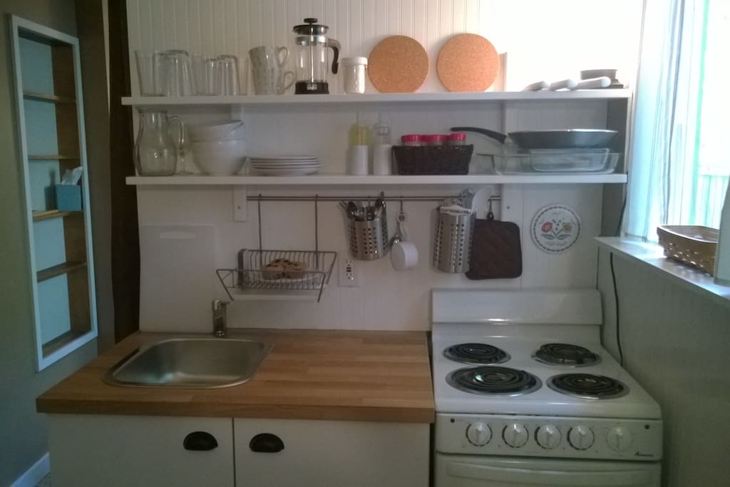 COVER #3 - Your kitchenette is stocked with basic dishes and cooking items. Spices, vinegar & oil, and coffee are on the shelves for your use.