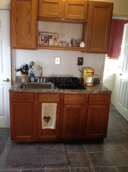 Kitchen, with microwave, refrigerator, and Keurig coffee pot.