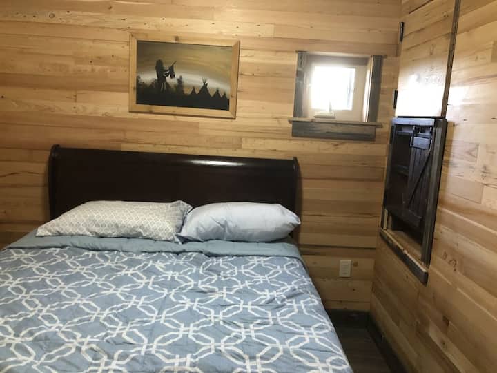 Master bedroom with queen bed and privacy door.