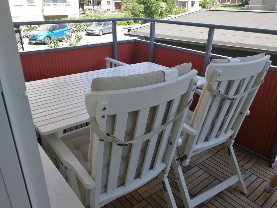The second balcony with a table, two chairs and a bench
