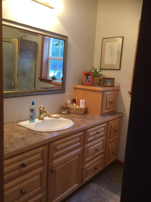 Beautiful bath with custom maple cabinetry, plush towels, plenty of toiletries.