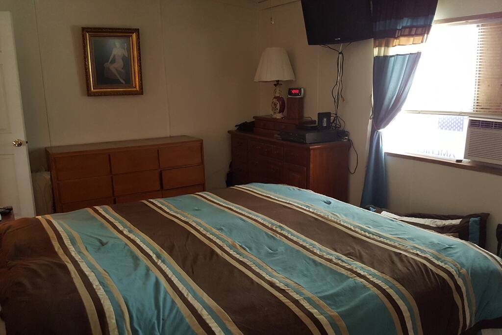Ca. King bed, room air conditioner, ceiling fan, touch on-off lamps at head of each side of the bed(his and hers:))
