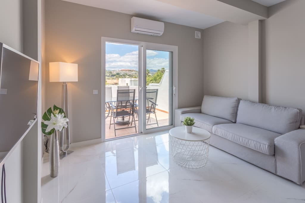 Brand new interiors and just fully renovated living room with marble floors and grey, modern walls