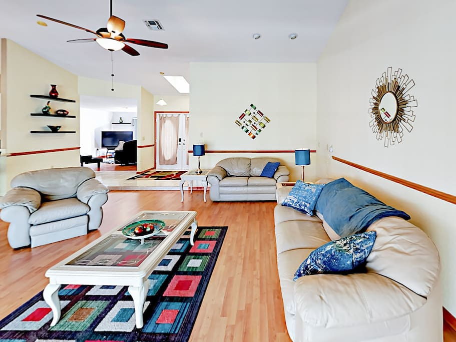 Open-concept living room with 60" flat screen TV and seating for 6. Wi-Fi is provided.