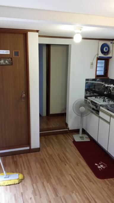toilet, kitchen and leading to the shower room