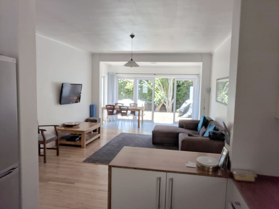 Open plan living room, dining room flowing out to a great deck space.