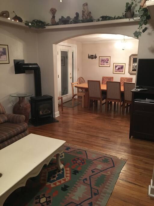 Evening in the living room. Large dining room table seats six-eight
