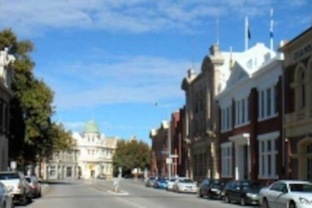 Phillimore Street looking to the entry to Harbourside which is through the lobby of the building on the right with brick and white surrounds to windows.