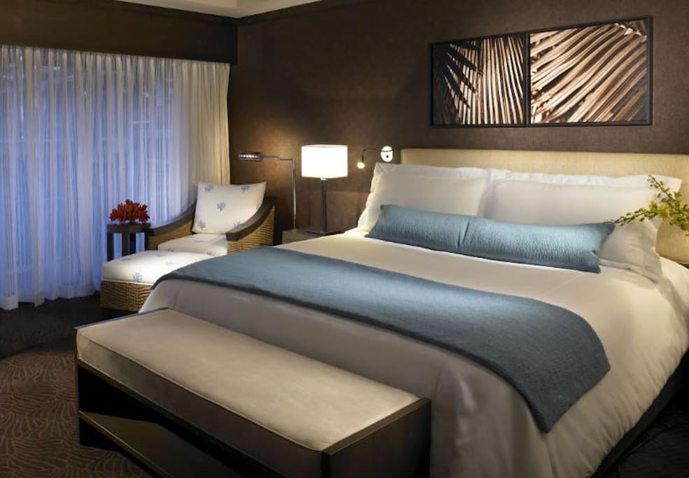 Sink into a cozy double bed with silky linens after a day in the sun.