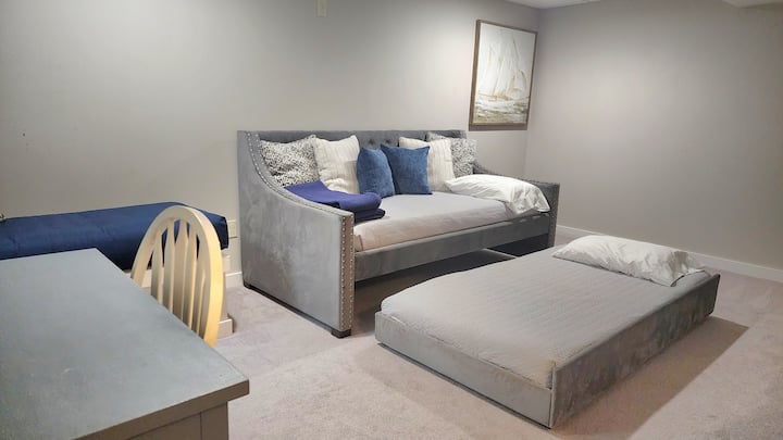 Our finished basement is great additional space for hanging out or sleeping. 

The basement includes a twin day bed w/ trundle, game closet, & a desk. There is also a smart TV. (Stream your own accounts)