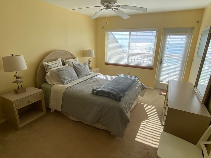 2nd master with king bed, private bath, tv  and access to balcony overlooking the beach.