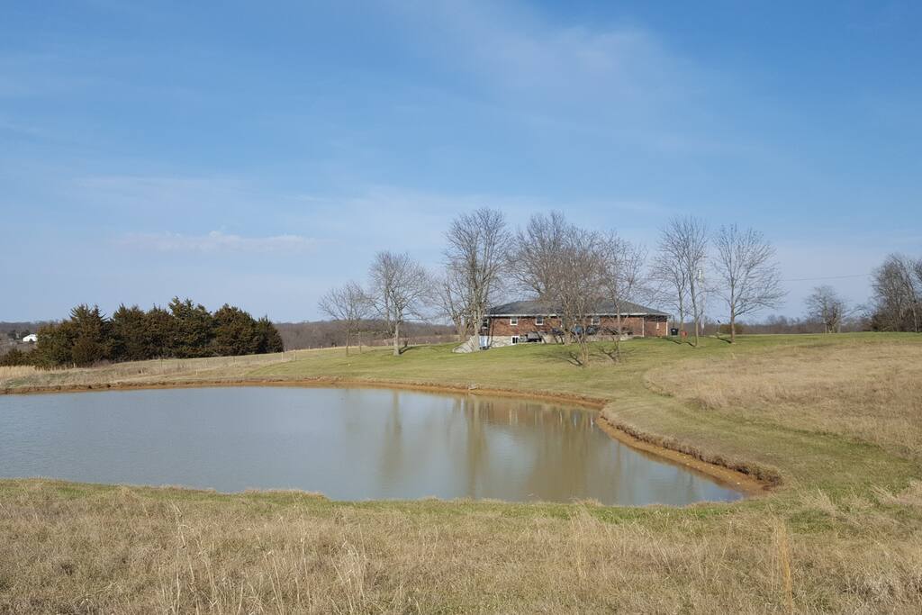 A picture of the back of the house from the pond.