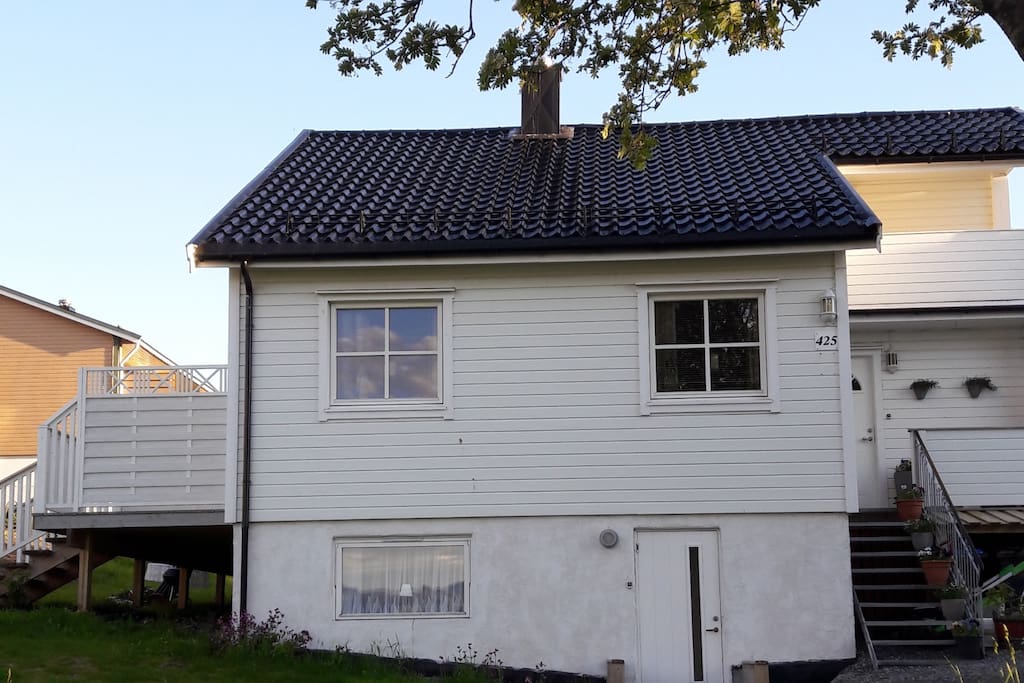 Front of the house. Entry to the apartment can be seen in front on ground level.