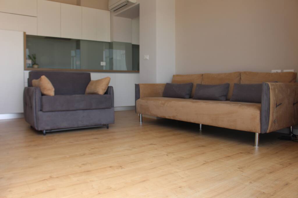 creatively designed space combining living room and kitchen