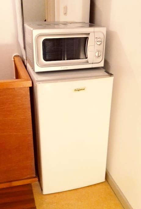 Refrigerator and microwaves at the door of the private Bedroom.
