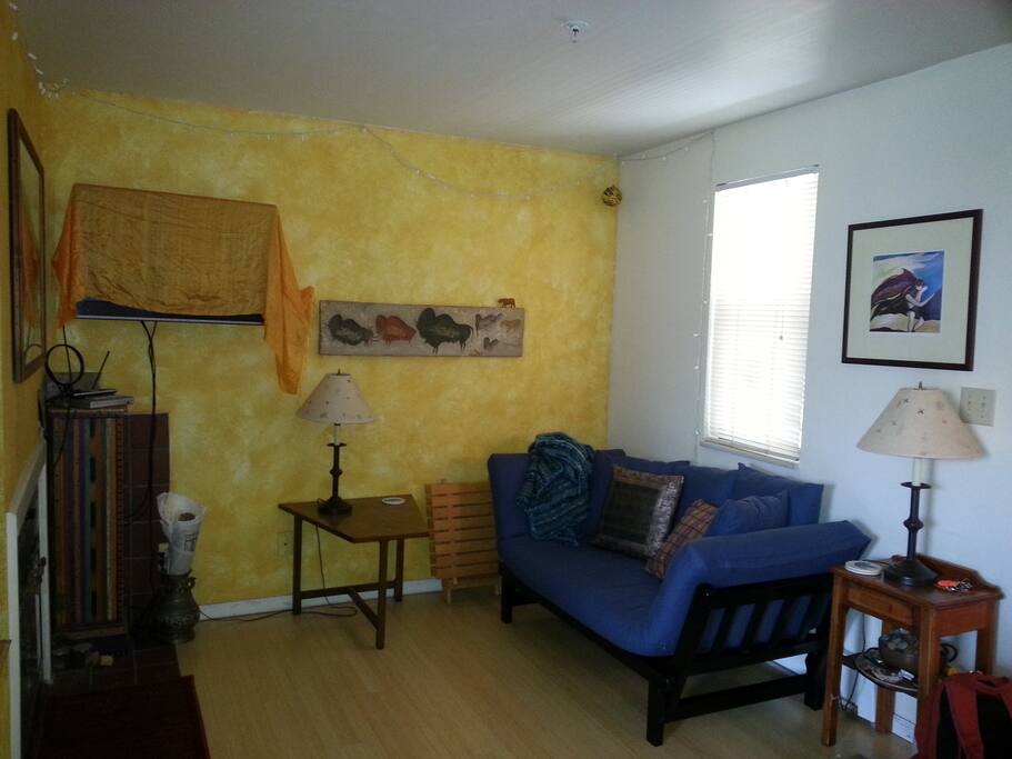 Living room with couch that folds out to single person bed.