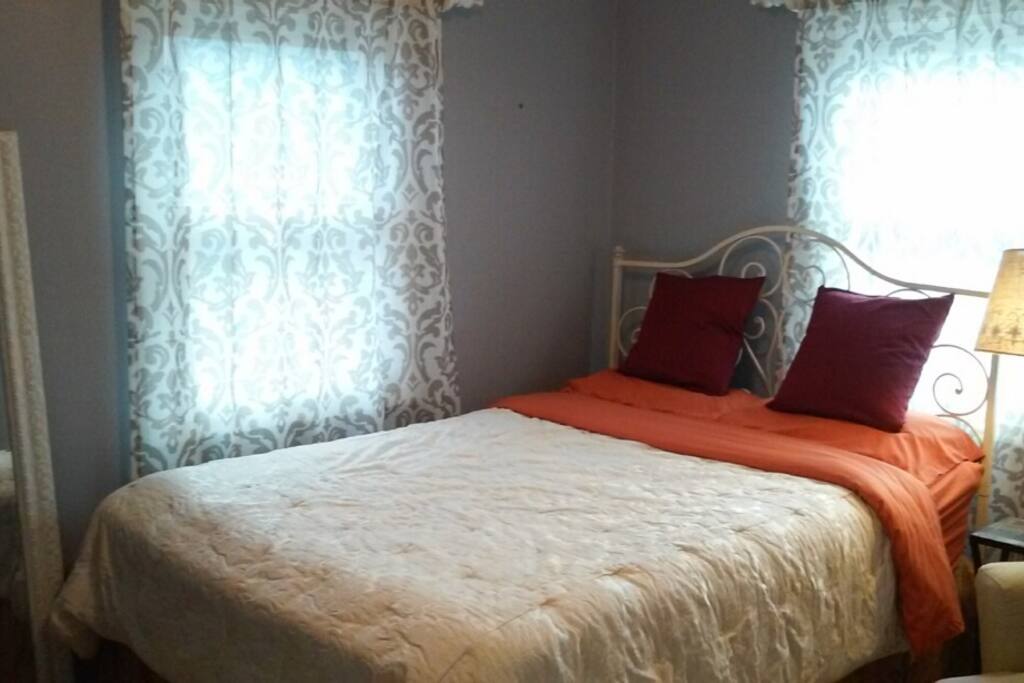 Queen size bed with custom bedding