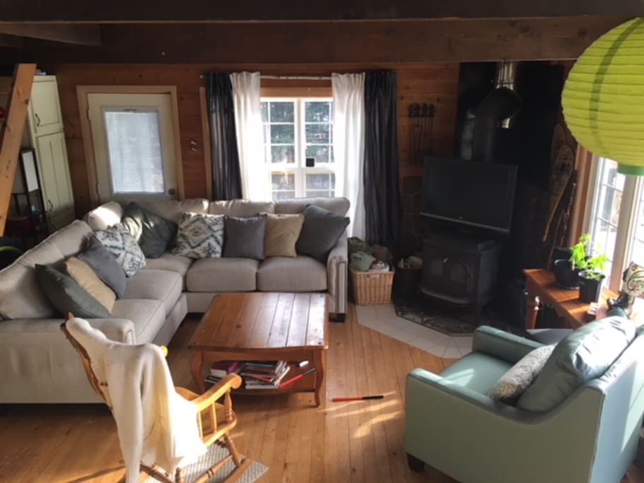 Open and bright living room with wood stove